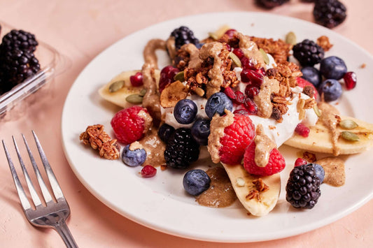 Recipe for breakfast banana split, featuring fresh fruit, Michele's Cocoa Chocolate Chip Granola, and granola butter