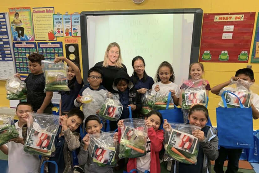 Photo courtesy TasteWise Kids - children proudly show off salad-making kits for healthy eating at home