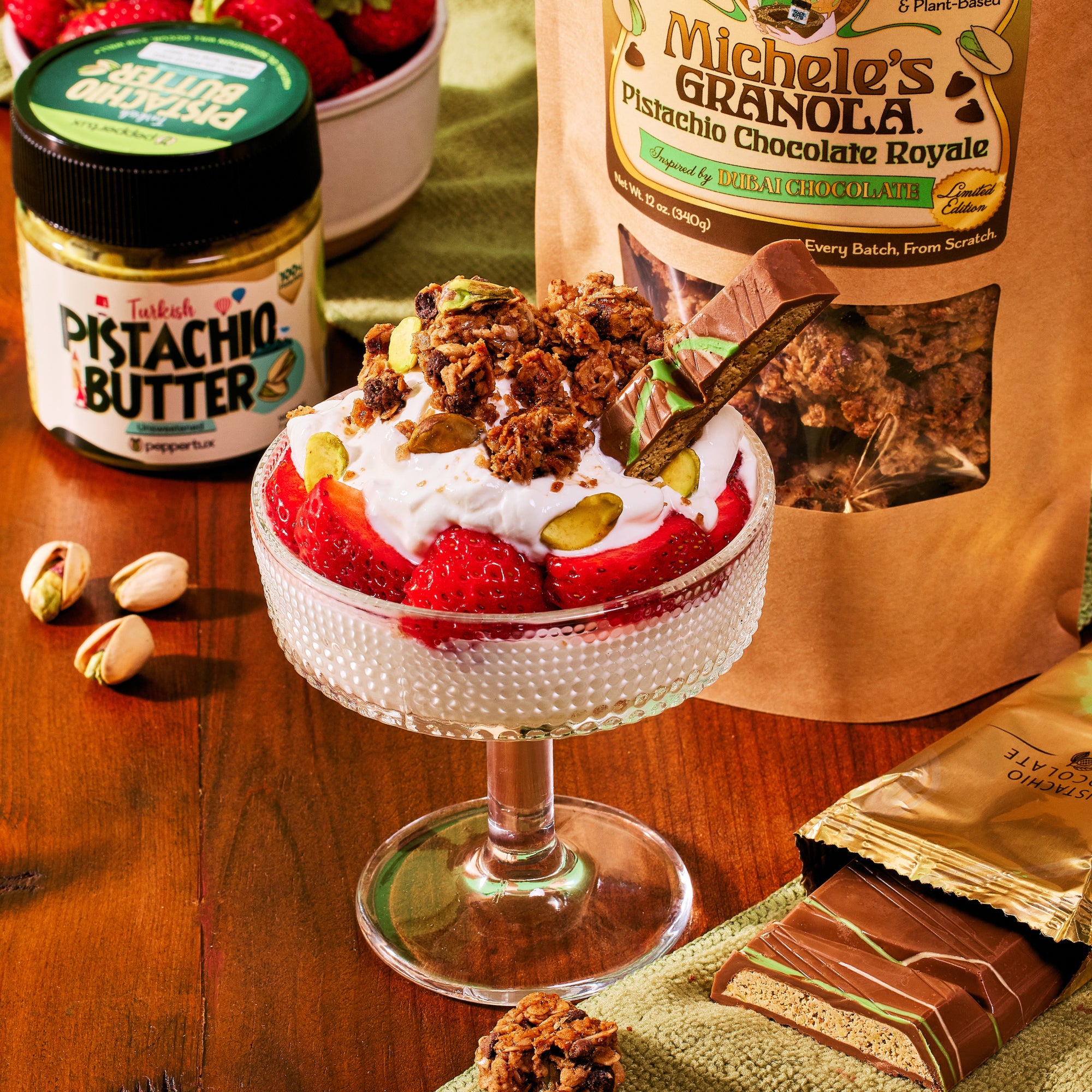 Parfait of Michele's Granola Pistachio Chocolate Royale with Dubai chocolate and a jar of Peppertux Turkish Pistachio Butter