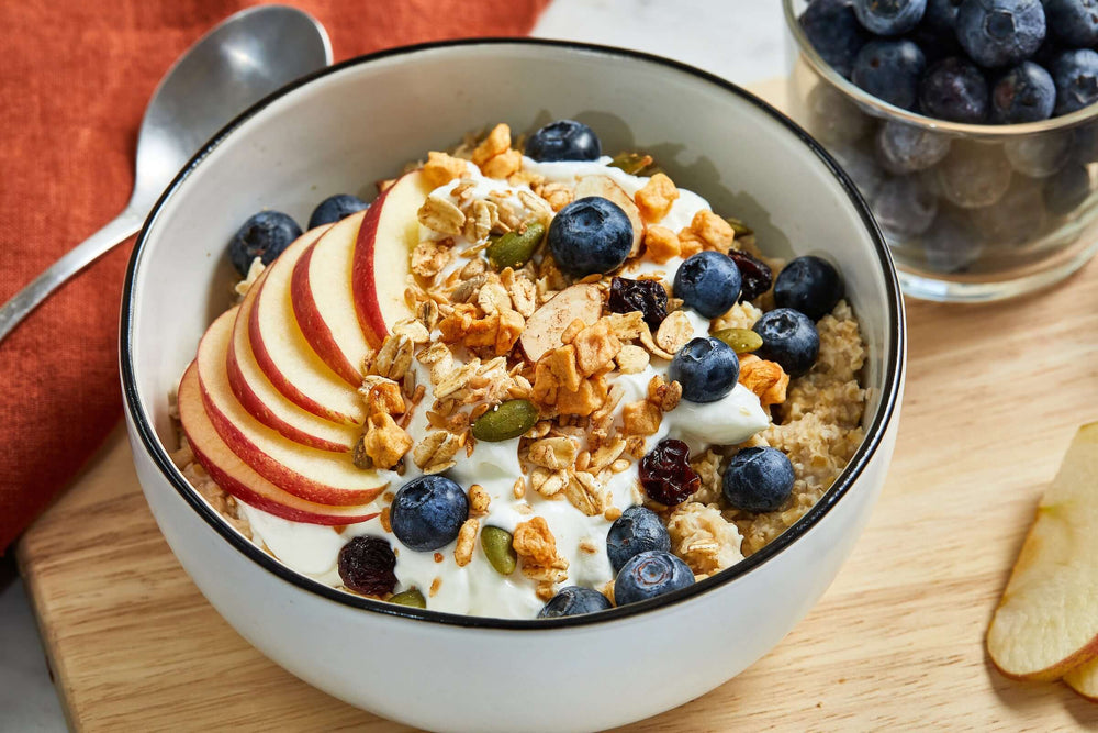A bowl of oatmeal topped with Michele's Toasted Muesli - vegan, gluten-free, low sugar