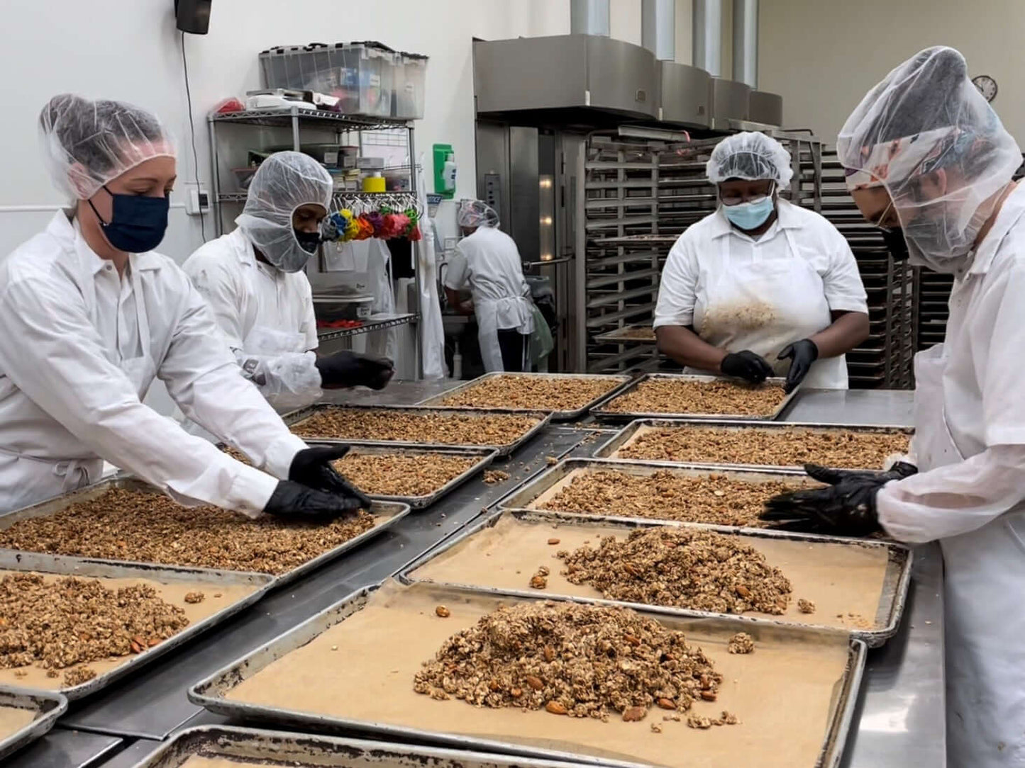Michele's Granola team making granola by hand