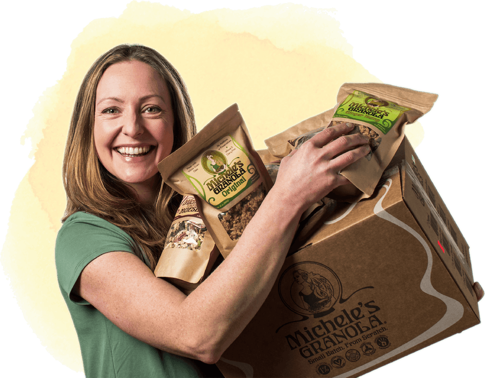 Michele, Founder and Owner of Michele's Granola, with bags of granola